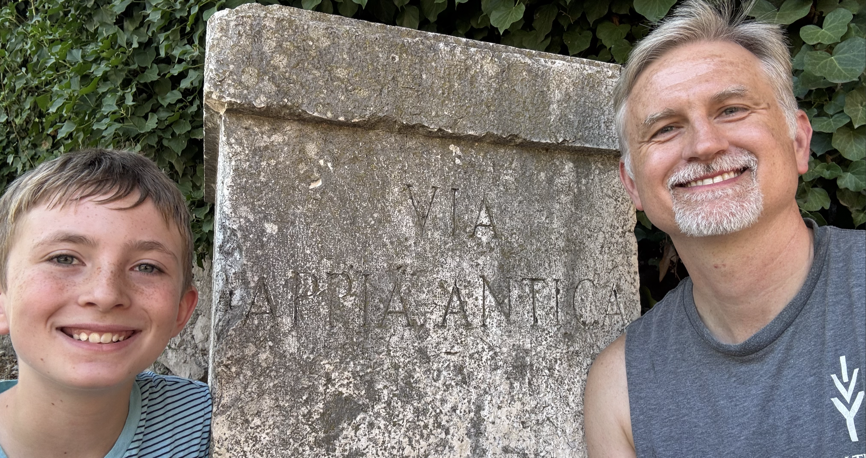 Mr. A and his son in front of the Via Appia road sign